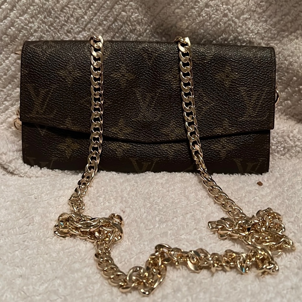 Louis Vuitton wallet on a chain.